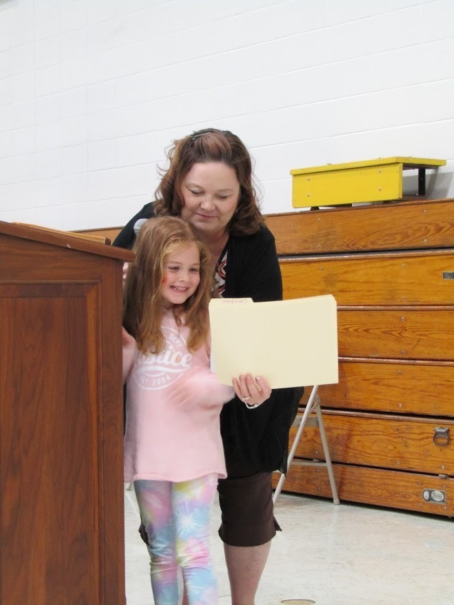 Mrs. Sandgren gives  awards to Pre School on the last day of school. 