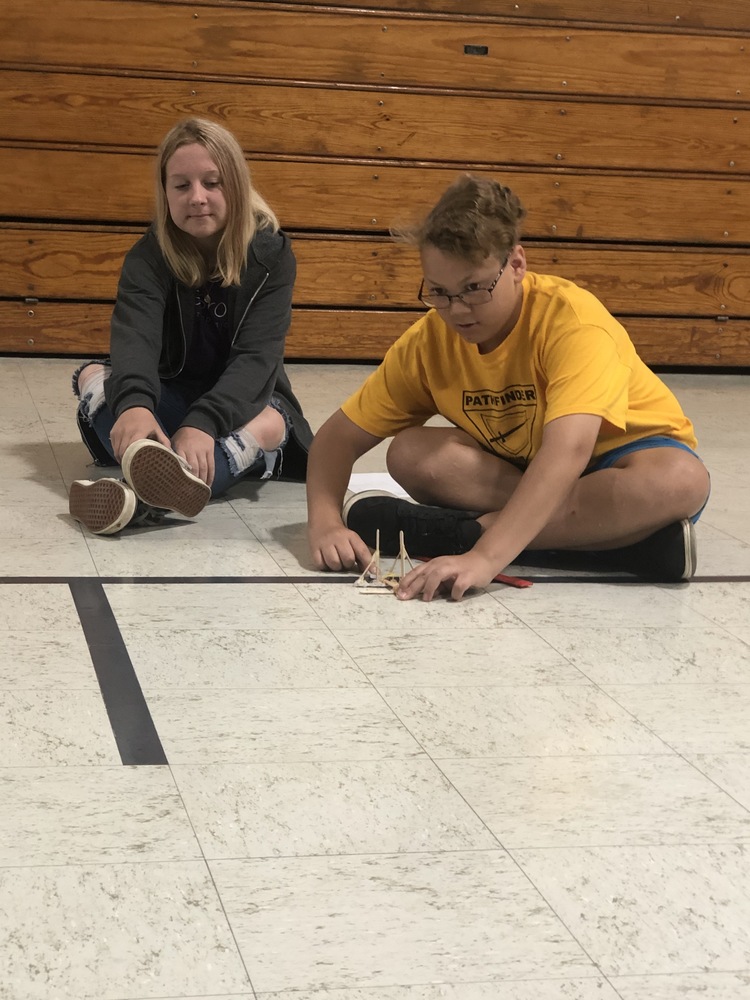 Kaleb and Kaylan prepare a catapult